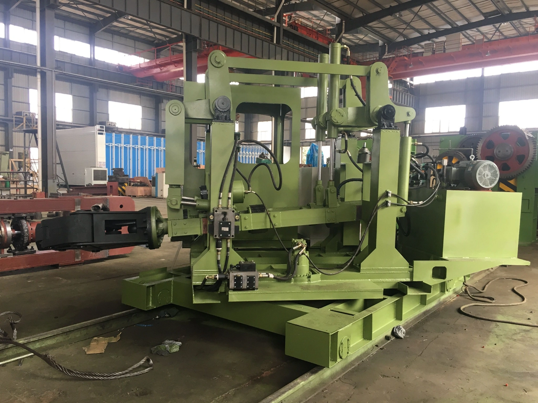 CNC forging manipulator handling a hot workpiece in an open die forging line